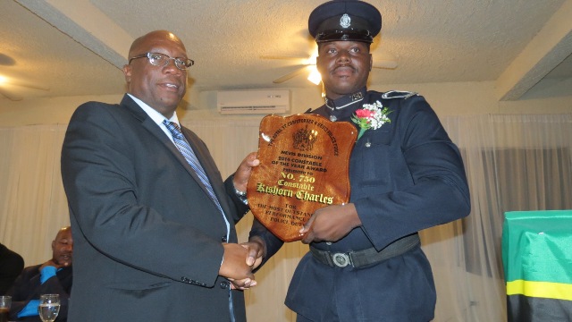 Constable of the Year of the Nevis Division of the Royal St. Christopher and Nevis Police Force #750 Kishorn Charles of the Violent Crimes Unit receiving his recognition plaque from Prime Minister and Minister of National Security Hon. Timothy Harris