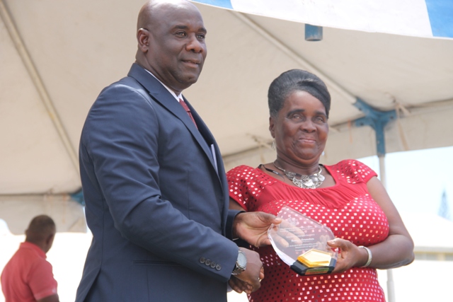 Minister of Agriculture on Nevis Hon. Alexis Jeffers presents a plaque to Patron of the Department of Agriculture’s 21st annual Open Day Roslyn Cranston at the opening ceremony at the Villa in Charlestown on March 26, 2015