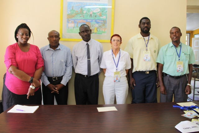 (L-R) Product Development Officer Nicole Liburd, Acting Permanent Secretary of Tourism Mr. Carl Williams, Policy and Regulations Officer in the Ministry of Tourism John Hanley and Taxi Drivers of the Queen City Taxi Association.