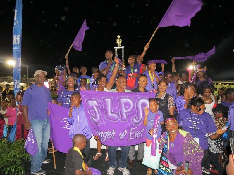 Athletes of the Joycelyn Liburd Primary School winners, of the 33rdGulf Insurance Inter-Primary School Champions celebrate with staff members and fans at the Elquemedo T. Willett Parkon April 01, 2015