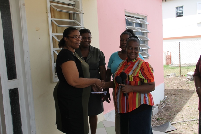 Gloria Pemberton of the Single Parents Group presenting Glenda Raymond with the monetary donation, on behalf of her husband Raymond Maynard