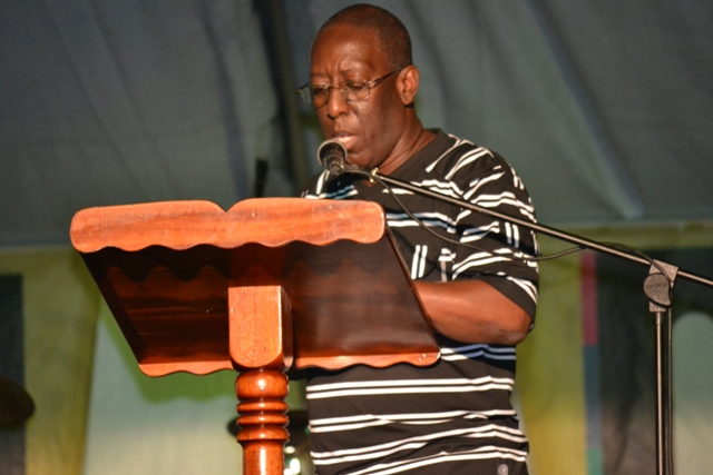 Executive Director of the Culturama Secretariat Abonaty Liburd reading profiles of the patron at the opening ceremony of Culturama 2015 at the Charlestown Waterfront on July 23, 2015
