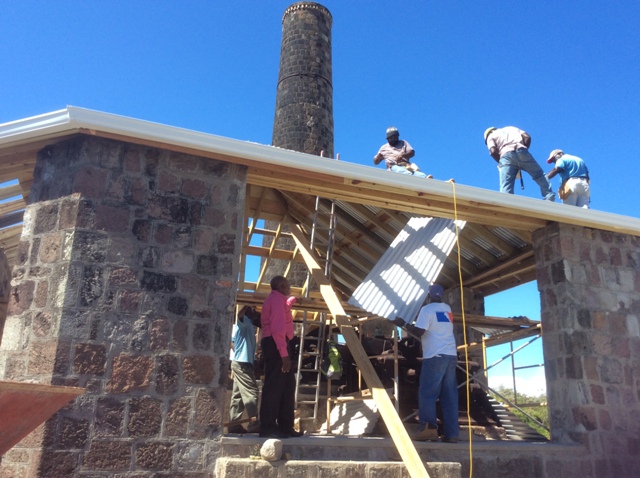 Workmen carrying out completion work on the roof of the building housing the sugar mill at New River Estate under the Ministry of Tourism’ s New River Rehabilitation Project