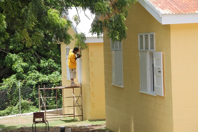 A young worker, one of several employed by a local contractor in rehabilitation works at the Charlestown Secondary School