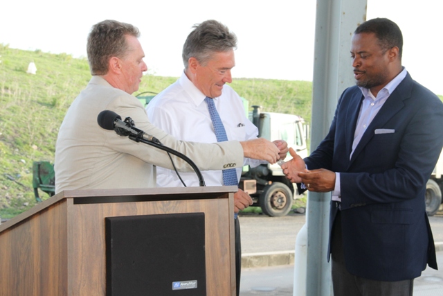 Deputy Premier and Minister of Health on Nevis Hon. Mark Brantley receives keys to two state-of-the-art Kenworth garbage collection trucks from Omni Global’s Caribbean Region Operation Manager Steve Hammond, Omni Global Representative Davis Johnson at a handing over ceremony at the Long Point landfill on September 17, 2015