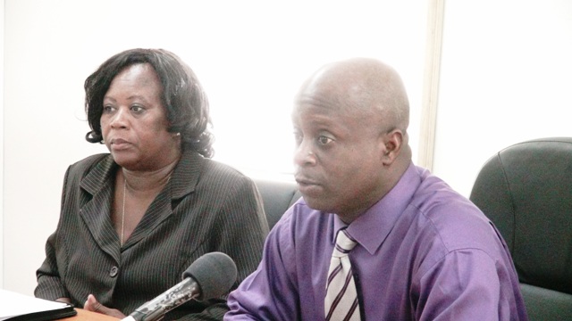 Permanent Secretary in the Premier’s Ministry Wakely Daniel (r) and workshop facilitator Senior Officer at the Immigration Department in the Ministry of National Security Alicia Huggins at the start of a workshop for immigration officers at the Cotton Ground Police Station on October 21, 2015