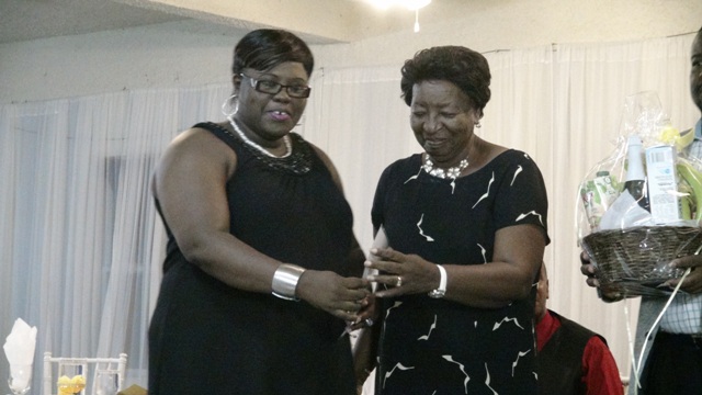 Junior Minister of Social Development Hon. Hazel Brandy-Williams presents award to Lorna Doras at the 3rd Annual Gala and Awards Ceremony hosted by the Department of Social Services Seniors Division at the Occasions Conference Centre on October 27, 2015