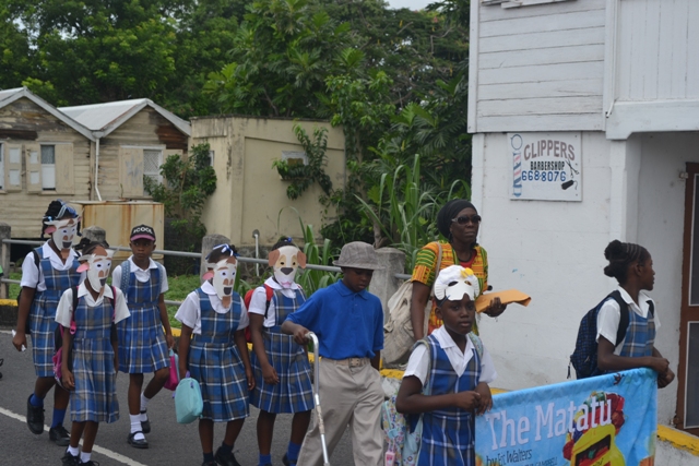 Students from the St. James’ Primary School among the students marching through Charlestown at the start of the first Rainforest of Reading Book Festival on November 06, 2015