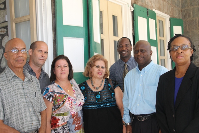 (L-R) Secretary/Translator at the Cuban Embassy in St. Kitts and Nevis Winston Hanley, Head of the local Cuban Brigade Yail Pérez, Officer in the Ministry of Health in Cuba in charge of Cuban doctors and nurses Michele Santana Iglesias, wife of the Cuban Ambassador to St. Kitts and Nevis and First Secretary in the Embassy of Cuba in the Federation Teresa Toranzo Castillo, Assistant Secretary in the Premier’s Ministry Kevin Barrett, Permanent Secretary in the Premier’s Ministry Wakely Daniel and Assistant Secretary in the Premier’s Ministry Angela Scarborough at the Nevis Island Administration on October 30, 2015