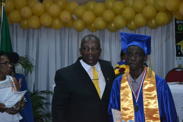 Valedictorian of the Charlestown Secondary School’s graduating class of 2015 (CCSLC)  Chris-Andrew Smith with Principal Edson Elliot moments after he is presented with the Principal’s Medallion at the Charlestown Secondary School and the Nevis Sixth Form College at their Graduation and Prize-giving Ceremony at the Cicely Grell-Hull Dora Stevens Netball Complex on November 11, 2015