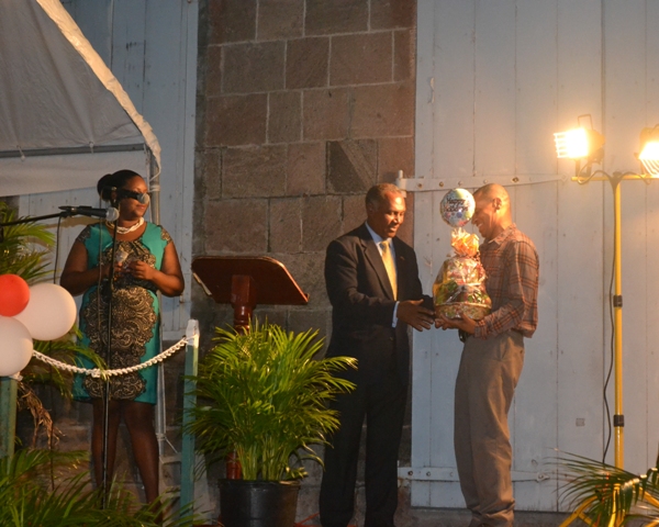 Premier of Nevis Hon. Vance Amory presents Patron of the Charlestown Christmas Tree Lighting Ceremony Steven Hanley with a gift basket, for his outstanding contribution to the community