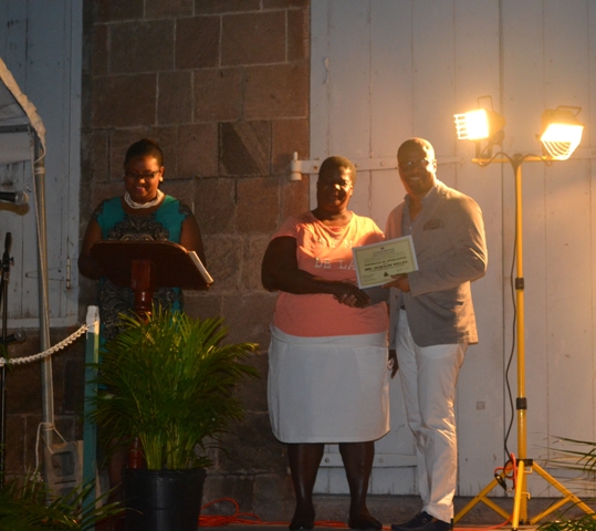 Minister of Social Development on Nevis Hon. Mark Brantley presents honouree Jacqueline Wallace of the St. Johns Parish with a certificate of appreciation, at the annual Charlestown Christmas Tree lighting Ceremony on December 02, 2015, for his outstanding contribution to the community Marjorie Brandy of St. Georges Parish, honoured for outstanding contribution to community development