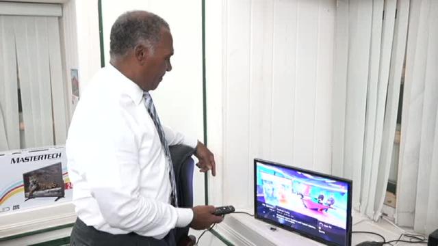 Premier of Nevis Hon, Vance Amory explores the Digicel Play gift package at his Bath Hotel office on March 09, 2016