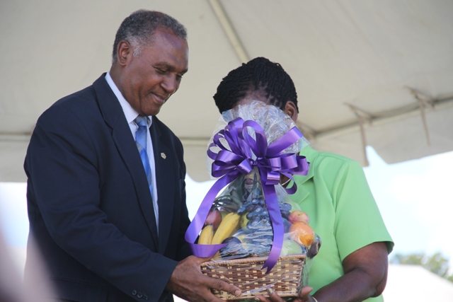 Premier of Nevis Hon. Vance Amory presents a fruit basket to the Department of Agriculture’s 22nd Annual Open Day Patron Dulcina Brookes-Byron at the opening ceremony at the Villa Grounds on March 17, 2016