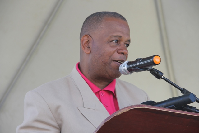 Permanent Secretary in the Ministry of Agriculture Mr. Eric Evelyn reading the profile of the Department of Agriculture’s 22nd Annual Open Day Patron Dulcina Brookes-Byron at the opening ceremony at the Villa Grounds on March 17, 2016