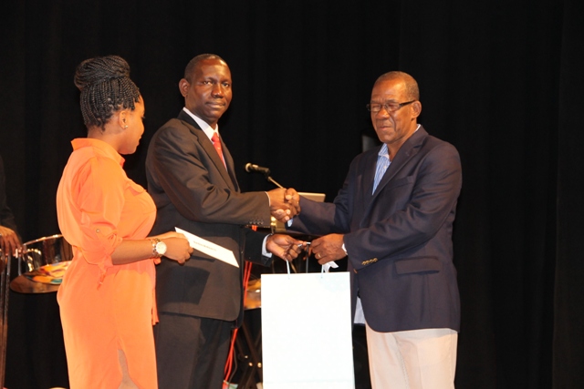 Errol Pemberton is awarded by the Ministry of Tourism on Nevis for his 35 years of photography service to Nevis at the awards ceremony for the Annual Photographer of the Year Competition 2016 at the Awards Ceremony at the Nevis Performing Arts Centre on March 18, 2016