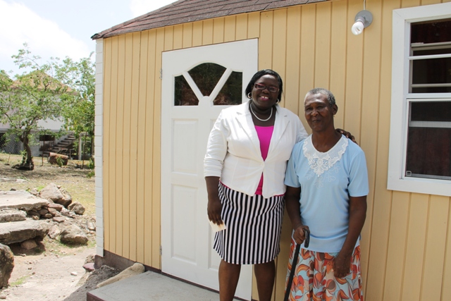 Junior Minister in the Ministry of Social Development Hon. Hazel Brandy-Williams with Ingrid Browne of Hickman’s Village on June 15, 2016, share a light moment after handing over keys to Browne for an extension of her home through the ministry’s Community Housing Project