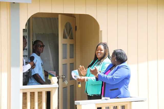 Egbert Clarke (second from right) with Permanent Secretary in the Ministry of Community Development Keith Glasgow (left) Junior Minister Hon. Hazel Brandy-Williams (extreme right) and Assistant Secretary Michelle Liburd (second from right) moments after receiving keys to an extension of the family home at Butlers Village on June 15, 2016