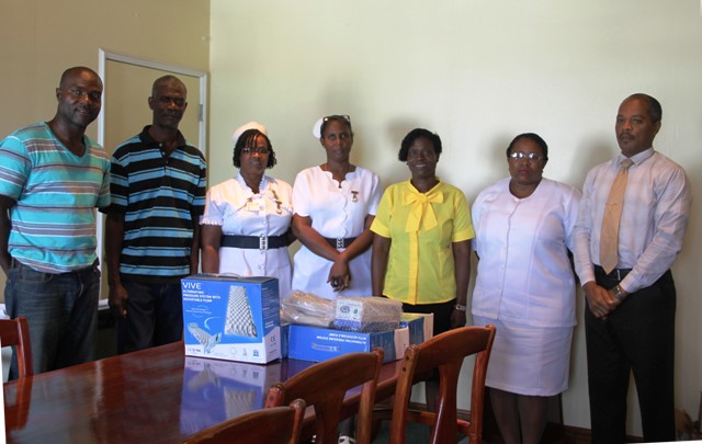 (L-r) Nigel Simmonds, Livingstone Simmonds, Assistant Nurse Manager Bernadette Jeffers, Nurse Manager Joya Parry-Lake, Lornette Webbe, Acting Matron Jessica Scarborough and Hospital Administrator Gary Pemberton with the gifts donated by the Simmonds Family to the hospital on July 14, 2016