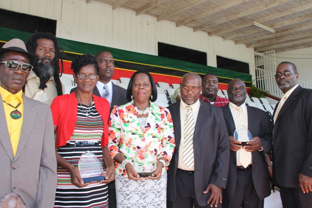 Awardees for the 33rd Independence Day Ceremonial Parade and Awards Ceremony (l-r back row) Merville Donavon Liburd, Stedvin Clarke and Wasim Richards representing his father Rawle “Ingy” Richards. (L-r front row) Errol “Jabal” Tyson, Viana Stapleton, Aldris Pemberton-Dias and Wrenford Dore, Allister Dore and Stephenson “Lanny” Dore of the Dore Brothers moments after they received their awards from Deputy Governor General His Honour Mr. Eustace John at the Ceremonial Parade and Awards Ceremony to mark the 33rd Anniversary of the Independence of St. Kitts and Nevis at the Elquemedo T. Willett Park on September 19, 2016