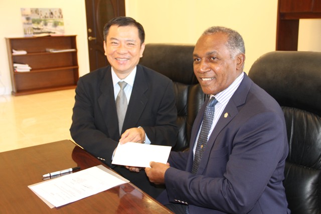 (L-r) Resident Ambassador of the Republic of China (Taiwan) to St. Kitts and Nevis His Excellency George Gow Wei Chiou presents a cheque on behalf of his government and people to Premier of Nevis Hon. Vance Amory for the procurement of equipment and a vehicle for the Information Technology Department in the Nevis Island Administration at the premier’s office at Pinney’s Estate on September 30, 2016
