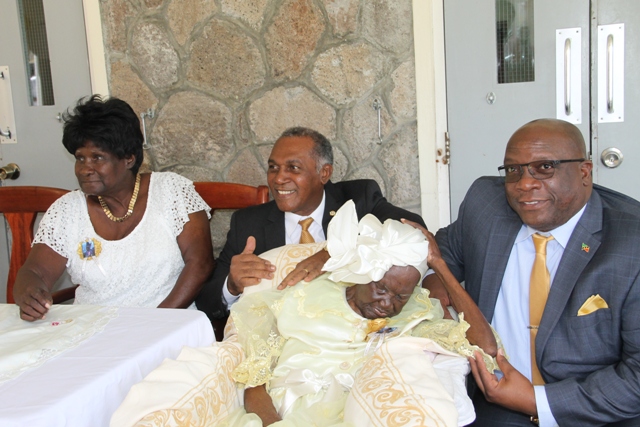 Prime Minister of St. Kitts and Nevis Hon. Dr. Timothy Harris (r) and Premier of Nevis Hon. Vance Amory with birthday girl Celian “Martin” Powell of Zion Village on her 105th birthday with her only surviving child Dulcina Browne on January 19, 2017 at the Flamboyant Nursing Home