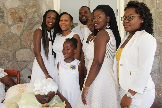 Celian “Martin” Powell’s great-granddaughter Charine Skelton (extreme left) and other great-grandchildren share a moment with their great-grandmother at her 105th birthday celebration on January 19, 2017 at the Flamboyant Nursing Home