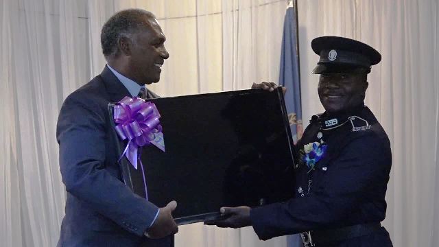 Hon. Vance Amory, Premier of Nevis and Minister of Security in the Nevis Island Administration presents the third place award to Constable Shayne James of the Gingerland Police Station, at the Royal St. Christopher and Nevis Police Force (Nevis Division) Constables’ Awards Ceremony and Dinner, hosted by the Strategic Planning Group on March 04, 2017, at the Occasions Entertainment Arcade at Pinney’s
