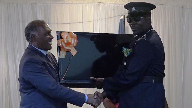 Hon. Vance Amory, Premier of Nevis and Minister of Security in the Nevis Island Administration presents Constable of the Year Award for 2016/2017, to Constable Kerran Nicholas of the Task Force Unit in the Royal St. Christopher and Nevis Police Force (Nevis Division) at the Constables’ Awards Ceremony and Dinner, hosted by the Strategic Planning Group on March 04, 2017, at the Occasions Entertainment Arcade at Pinney’s