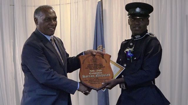 Hon. Vance Amory, Premier of Nevis and Minister of Security in the Nevis Island Administration presents Constable of the Year Award for 2016/2017, to Constable Kerran Nicholas of the Task Force Unit in the Royal St. Christopher and Nevis Police Force (Nevis Division) at the Constables’ Awards Ceremony and Dinner, hosted by the Strategic Planning Group on March 04, 2017, at the Occasions Entertainment Arcade at Pinney’s