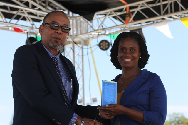 Mr. John King, Representative of IICA Delegations in the Eastern Caribbean States presents Principal of the Charlestown Primary School Ms. Latoya Jeffers for the school’s Outstanding Work in Agricultural Innovation in 2016 at the 23rd Annual Agriculture Open Day at the Villa Grounds on Nevis on March 30, 2017