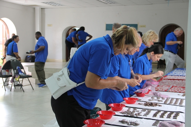 Members of the Starkey Hearing Foundation preparing hearing aids for fitting persons impaired hearing on their mission in Nevis at the Anglican Church Hall in Charlestown on June 08, 2017