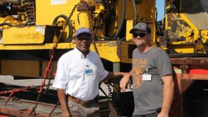 (Left-right) Mr. Mc Levon “Makie” Tross, Local Representative for the geothermal developers Nevis Renewable Energy International and Mr. David Griggs, Operations Manager DOSECC Exploration Services LLC, drilling contractors based in Salt Lake City with a section of the drill rig at the Long Point Port on its way to the N3 site in Hamilton Estate on November 02, 2017