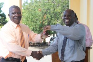 Mr. Edson Elliott, Education Officer in the Department of Education who is responsible for secondary schools at a handing over keys to the new addition to the Charlestown Secondary School to Principal, Mr. Juan Williams at a handing over ceremony at the school compound on December 13, 2017