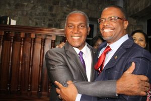 Premier of Nevis Hon. Mark Brantley (right) with immediate past Premier of Nevis Hon. Vance Amory embrace soon after Mr. Brantley was sworn in as premier at the High Court in Charlestown on December 19, 2017