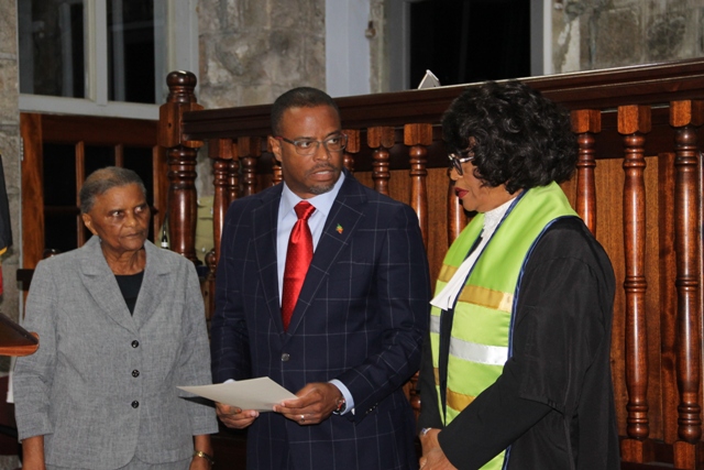 New Premier of Nevis Hon. Mark Brantley with his Instruments of Appointment in hand, moments after Acting Deputy Governor General Her Honour Mrs. Marjorie Morton (right) presented them to him at a special sitting of the High Court in Charlestown, on December 19, 2017. Her Ladyship the Hon. Justice Pearletta Lanns looks on