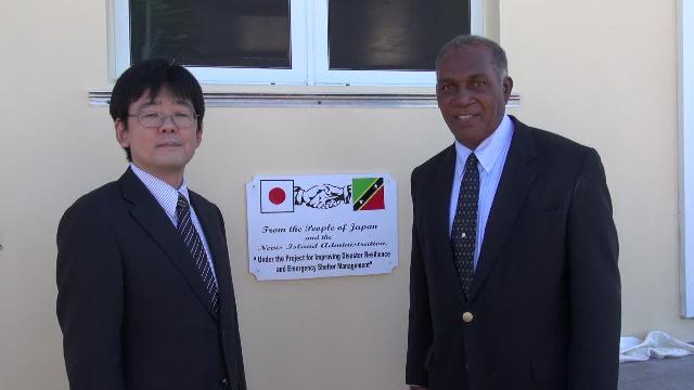 (l-r) Mr. Hideaki Fujiyama, Second Secretary at the Embassy of Japan to St. Kitts and Nevis and Hon. Vance Amory, Premier of Nevis moments after unveiling a plaque on the Albertha Payne Community Centre at Bath Village recently, at the closing ceremony of the Japan funded Improving Disaster Resilience and Emergency Shelter Management Project on Nevis