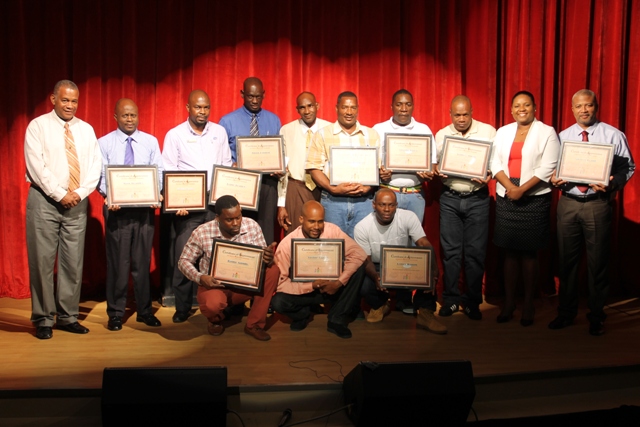 (l-r standing) Hon. Eric Evelyn, Minister of Youth and Community Development; Mr. Wakely Daniel, Permanent Secretary in the Premier’s Ministry; Mr. Warren Moving, TDC Representative; Mr. Alton Liburd, Assistant Superintendent of Prisons; Mr. John Prentice, Founder of the Circle of Peace Youth Programme; Mr. Ricky Ferlance, Winner of the Poetry Competition; Mr. Lumumba Matthew; second place winner, Mr. James Allen; awarded for his efforts resulting in a remarkable improvement in his performance; Ms. Zahnela Claxton, Director of Youth; Hon. Spencer Brand at the end of the Circle of Peace Youth Programme award ceremony at the Nevis Performing Arts Centre on January 23, 2018