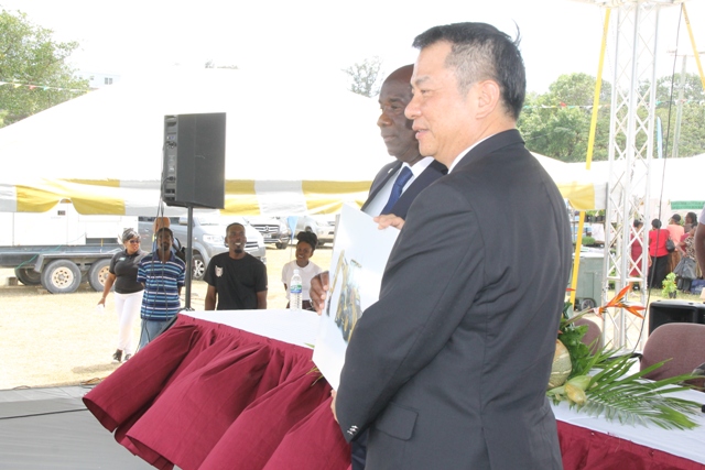 Republic of China (Taiwan) Resident Ambassador to St. Kitts and Nevis His Excellency Chiou Gow-Wei (left) presents Minister of Agriculture Hon. Alexis Jeffers with a cheque of US$1400,000 at the Department’s 24th Annual Open Day opening ceremony at the Villa Grounds on March 22, 2018, to purchase a backhoe for land clearing on Nevis