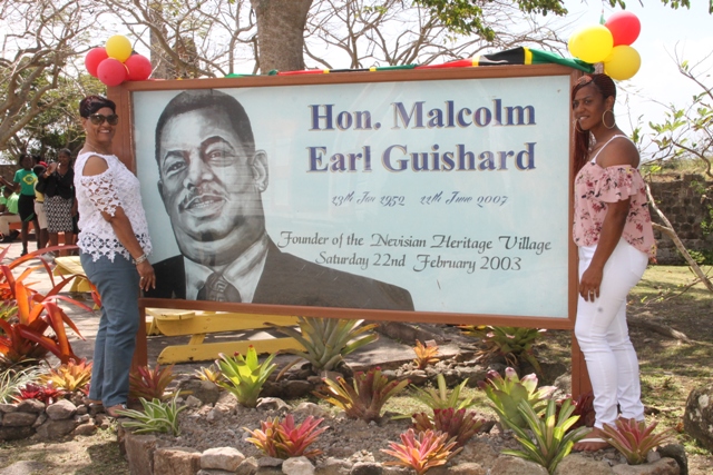Mrs. Yvonne Guishard (left), widow of the late Mr. Malcolm Guishard, Former Minister of Culture on Nevis and their daughter Shenelle moments after signage was unveiled in his honour at a ceremony marking the 15th anniversary of the Nevisian Heritage Village in Gingerland on February 22, 2018
