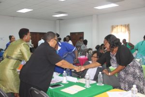 Participants greeting each other at the Department of Gender Affairs’ Health is Wealth Seminar for Women and Girls at the St. Paul’s Anglican Church Hall on March 08, 2018