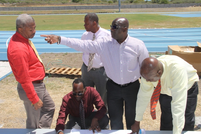 (Standing l-r) Hon. Spencer Brand, Minister of Communication and Works, Hon. Eric Evelyn, Minister of Youth and Sports, Acting Premier of Nevis Hon. Alexis Jeffers and Cabinet Secretary Mr. Stedmond Tross with Mr. Kevin Barrett, Permanent Secretary in the Ministry of Education (front) checking on progress at the Mondo Track project at Long Point on March 20, 2018