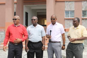 (L-r) Hon Spencer Brand, Minister responsible for Public Works on Nevis, Dr. Ernie Stapleton, Permanent Secretary in the Ministry of Communications and Works, Mr. Deora Pemberton, Direct of the Public Works Department and Mr. Denzil Stanley, Assistant Permanent Secretary in the Ministry of Communications and Works, standing in front of the new administrative block during their visit to the Gingerland Secondary School on April 20, 2018