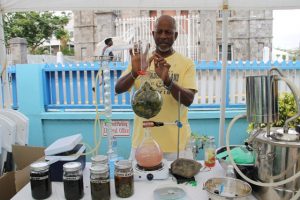 Mr. Evan Nisbett, one of the participants producing hydrosols from avocado pear leaves at the expo on May 23, 2018, at the end of the Essential Oils Workshop, hosted by the Small Enterprise Development Unit in the Ministry of Finance on Nevis