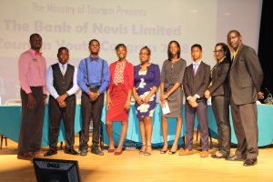 (l-r) Pheon Jones, Marketing Offer at the Bank of Nevis; Mr. Mikkel Maloney and Mr. Recardoe Rodriques, participants of the Charlestown Secondary School; Ms. Shai-Ann Tyson and Ms. K-Tara Huggins, participants of the Gingerland Secondary School; Ms. Eliyse Thomas and Mr. Kephra Grandison participants of the Nevis International Secondary School; Ms. Oksana Williams, Tourism Youth Congress Coordinator; and Mr. John Hanley, Acting Permanent Secretary in the Ministry of Tourism at the 11th staging of the Bank of Nevis Ltd. Tourism Youth Congress on May 17, 2018 at the Nevis Performing Arts Centre