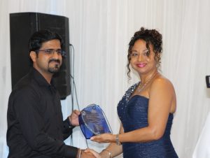 (l-r) Mr. Shankar Wadhwani, Assistant Manager at Rams Supermarket in Nevis receives the Ministry of Tourism’s 2018 Tourism Partner of the Year Award on behalf of Rams Nevis Limited from First Lady Mrs. Sharon Brantley at the ministry’s Tourism Awards Gala and Dance at the Four Seasons Resort, Nevis on May 26, 2018