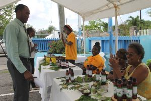 Participants introducing their finished products to the public at the end of a two-week Essential Oils Workshop, hosted by the Small Enterprise Development Unit in the Ministry of Finance on Nevis at a mini expo in Charlestown on May 23, 2018