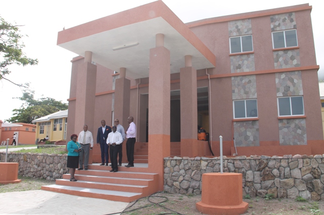 Cabinet members of the Nevis Island Administration on the steps of the new office complex at the Gingerland Secondary School during a tour of the facility on July 06, 2018