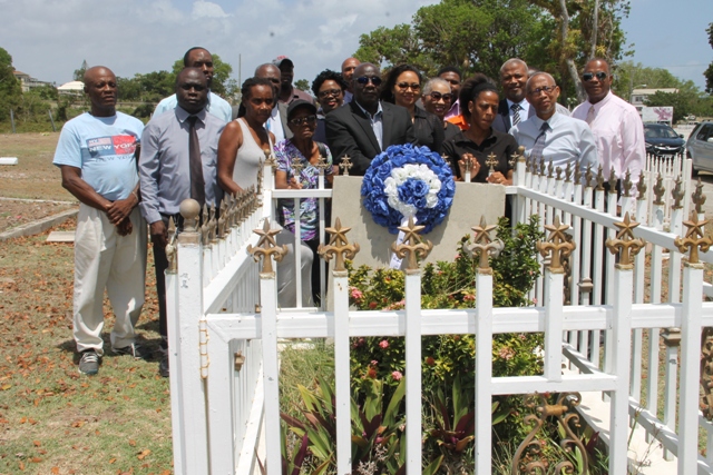 Hon. Alexis Jeffers (5th from left, first row) colleague ministers in the Nevis Island Administration and well-wishers at the grave-site of the late Malcolm Guishard to mark the 11th anniversary of his passing on June 11, 2018 at Bath Cemetery. First Lady Mrs. Sharon Brantley stands on his immediate right and Ms. Shenelle Guishard, daughter of the late Mr. Guishard stands on her immediate right