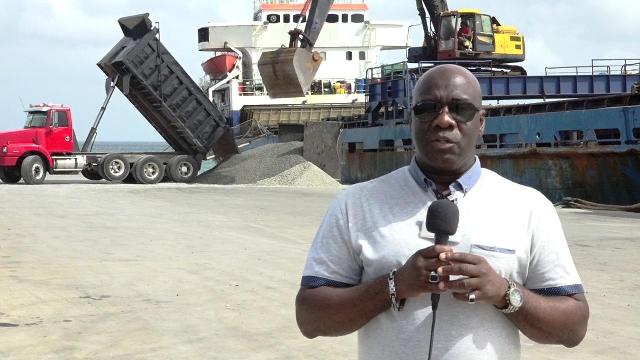 Hon. Alexis Jeffers, Acting Premier of Nevis and Minister responsible for Natural Resources in the Nevis Island Administration, at the Long Point Port witnessing a barge from Guyana loading aggregate at the Long Point Port on July, 17, 2018